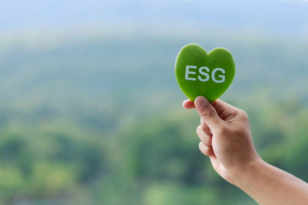 Hand holing green leaf saying ESG